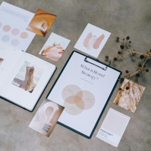 Flat lay of branding strategy materials with moodboard and color palette for creative design.